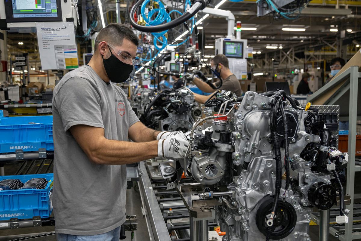 A technician works on the three-cylinder engine slated for the 2022 Rogue.