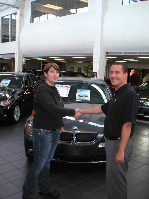Car dealer and customer shaking hands