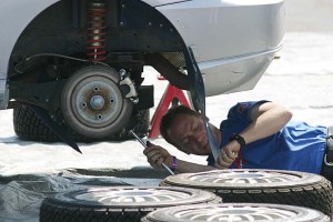 auto mechanic working under a car